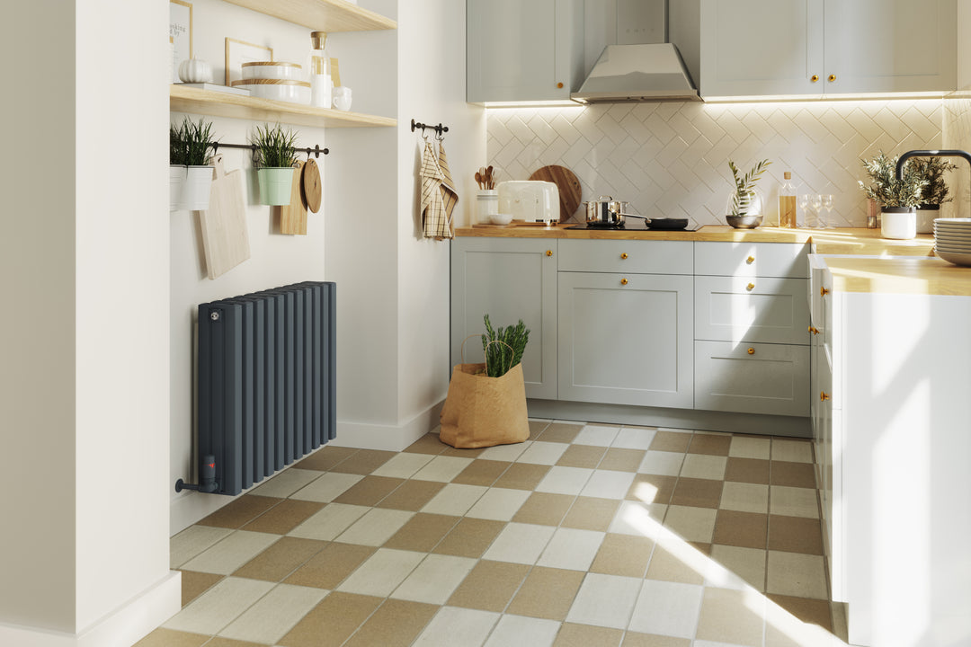 n anthracite aluminium radiator in a warm and inviting kitchen with checked tile flooring and pale blue cabinets.