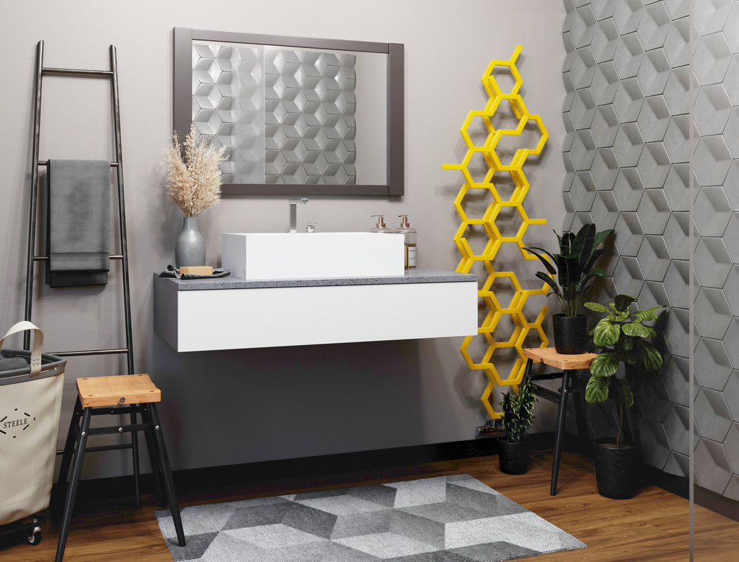 A modern bathroom featuring the mustard-yellow ‘Hex’ radiator from UK Radiators, which is made up of hexagons to resemble a beehive.