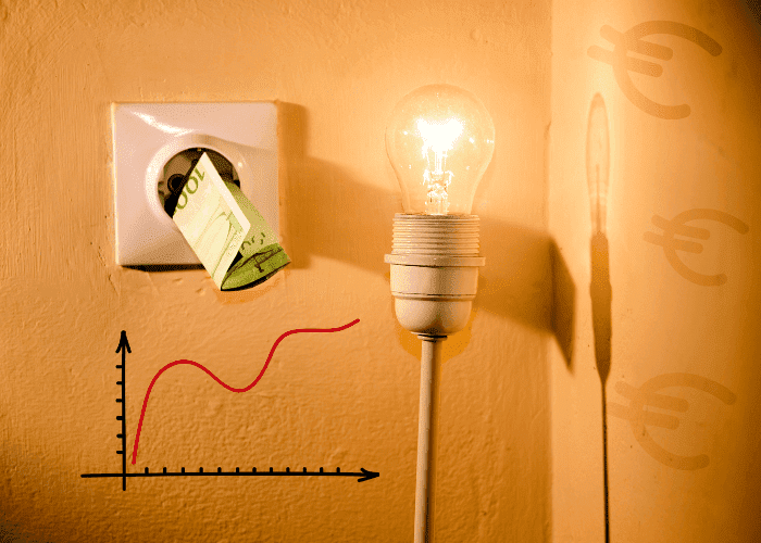 Illuminated light bulb beside an electrical outlet with euro banknotes, symbolising rising energy costs with a red graph line.