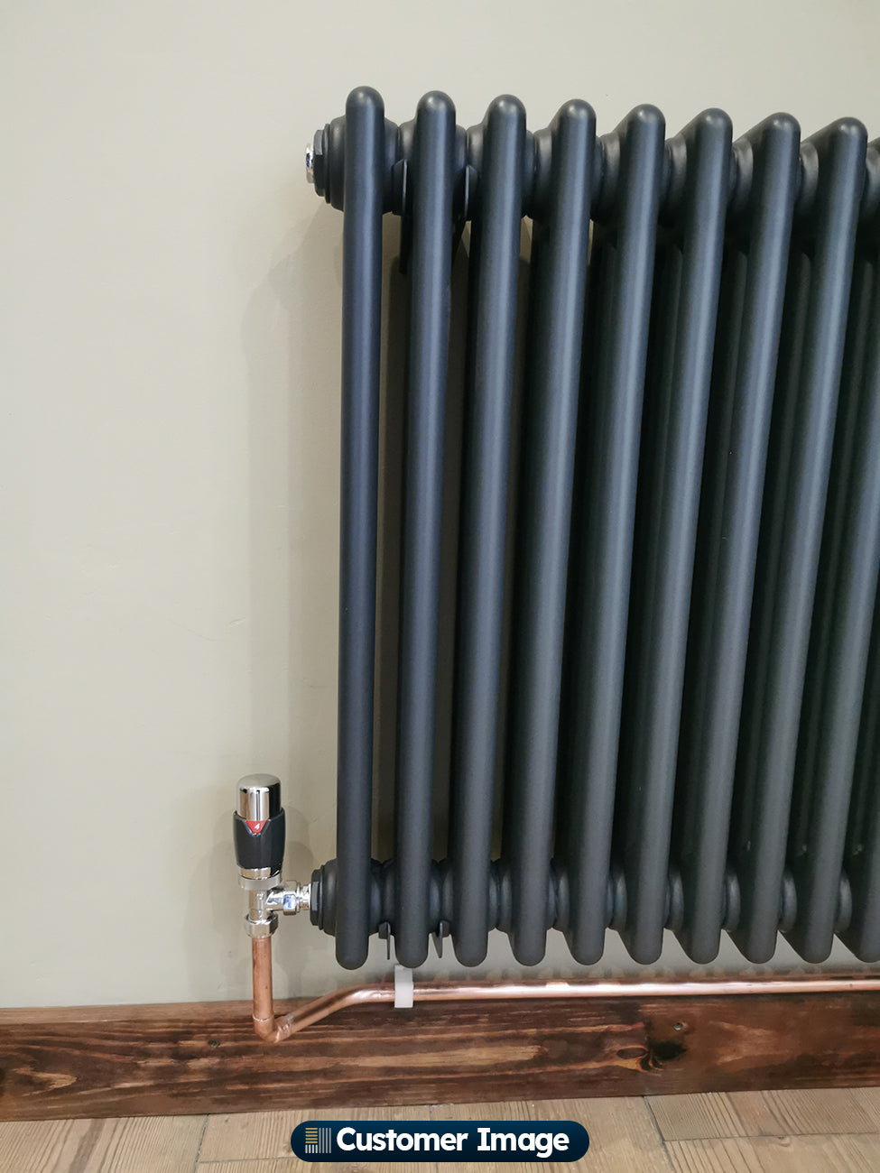 UK Radiators Talus Flair Thermostatic Radiator Valve Anthracite Angled installed in hallway