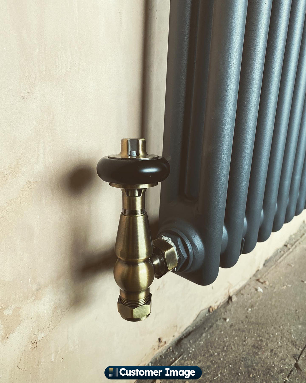 UK Radiators Signature Wooden Head Thermostatic Radiator Valve Antique Brass Angled installed in room