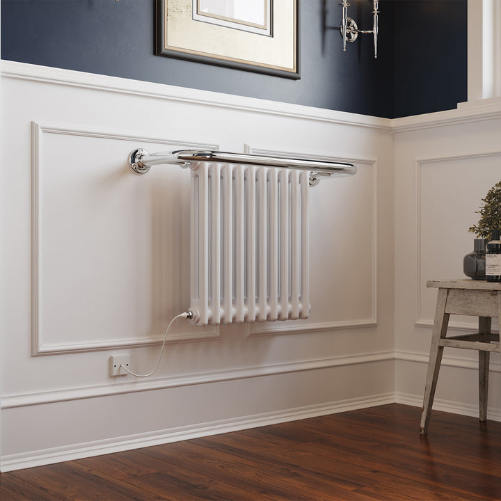 Aydon traditional electric towel rail, 491mm x 741mm, 300W standard white radiator, mounted on a white wall with wooden floor