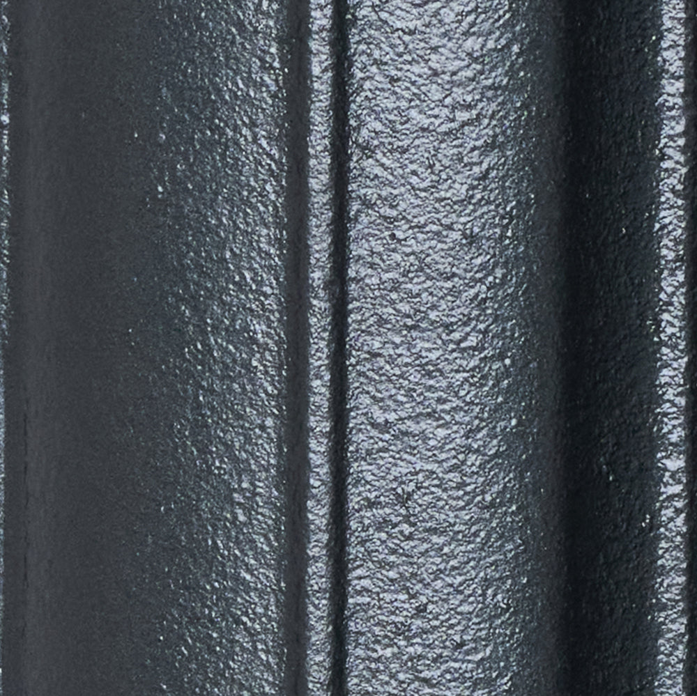 Close-up of the Pencil Grey cast iron radiator finish on a curved column surface.