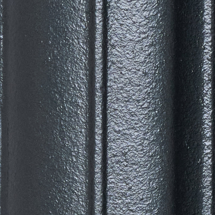 Close-up of the Pencil Grey cast iron radiator finish on a curved column surface.